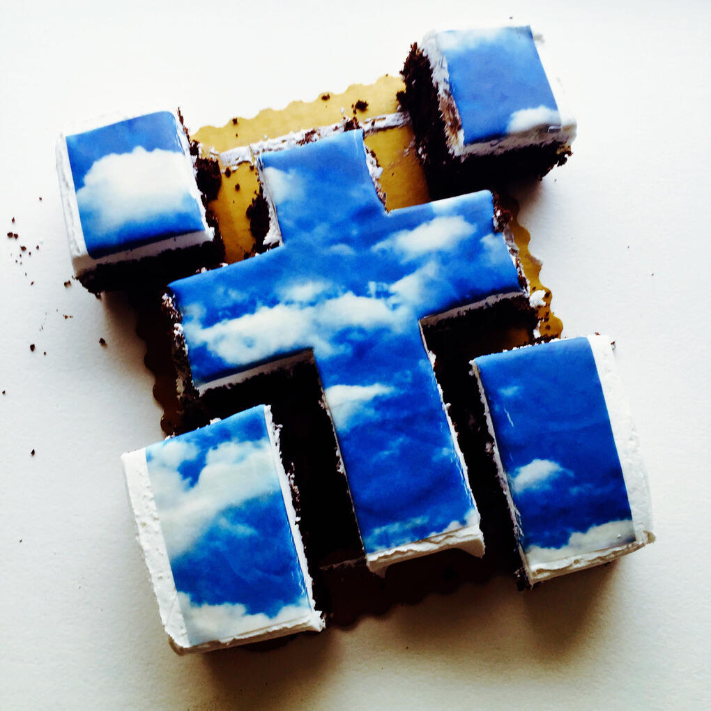 Custom ordered cloud themed cake, cut into cross shape